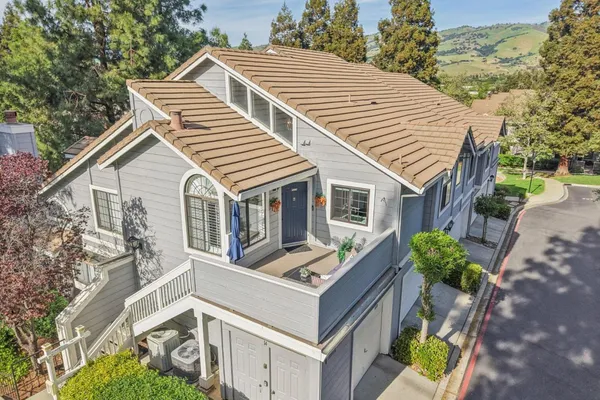 a front view of a house with a yard and trees