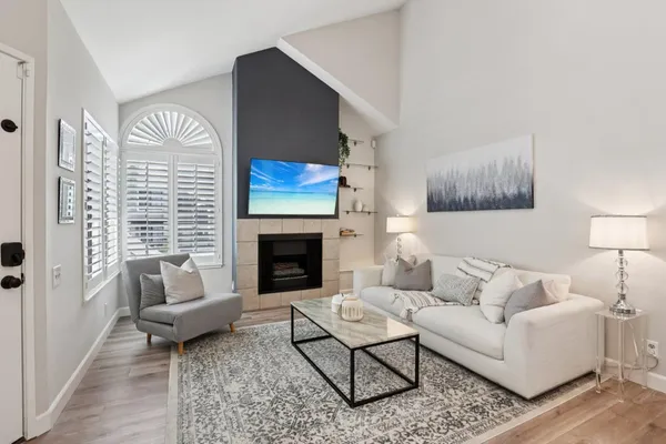 a living room with furniture and a fireplace