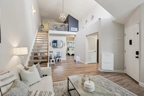 a living room with furniture and a wooden floor