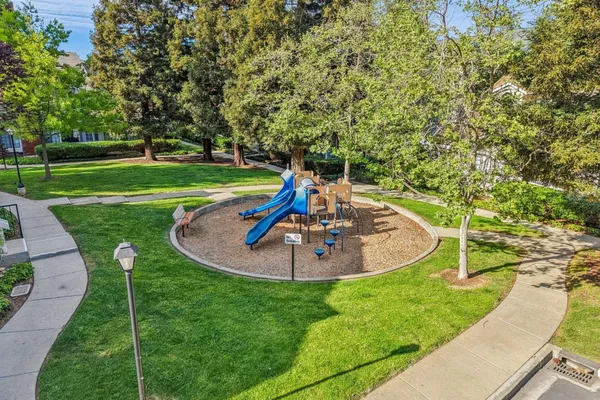 an aerial view of a house with a yard and garden