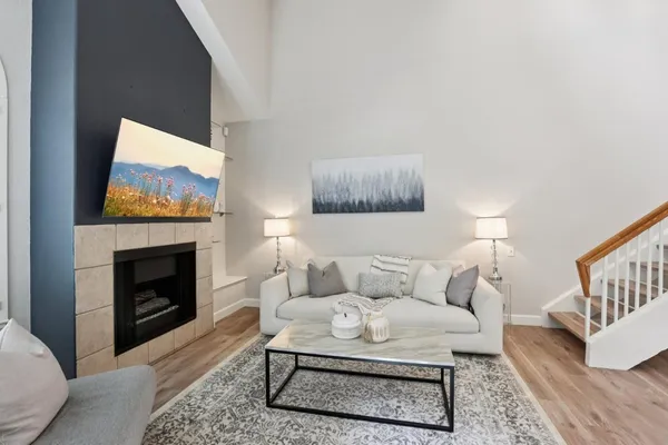 a living room with furniture a fireplace and a flat screen tv
