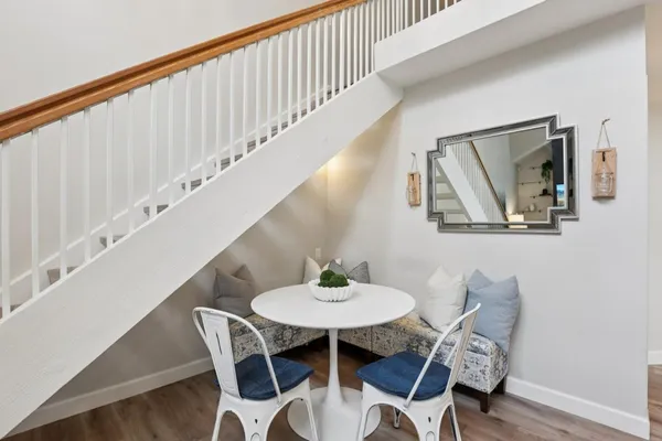 a dining room with furniture and wooden floor