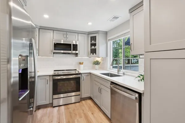 a kitchen with a sink stove and refrigerator
