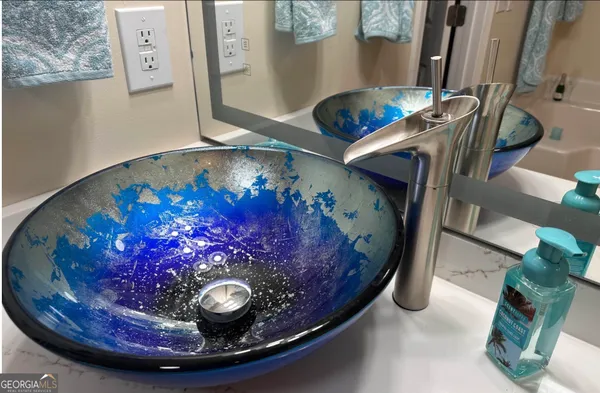 a bathroom with a sink mirror and toilet