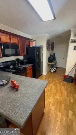 a kitchen with stainless steel appliances granite countertop a stove a sink and a refrigerator