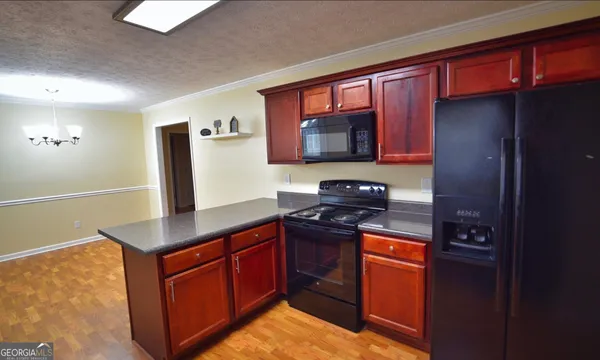 a room with a bed and a television