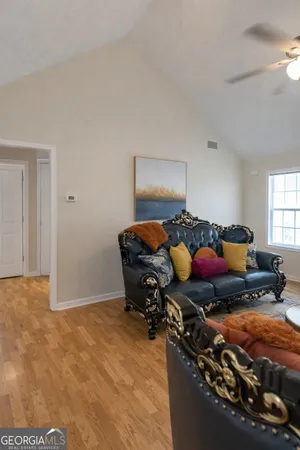 a living room with furniture and a chandelier