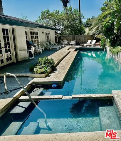 a view of swimming pool with lounge chair