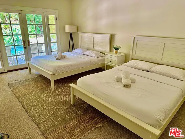 a spacious bedroom with two beds and a table