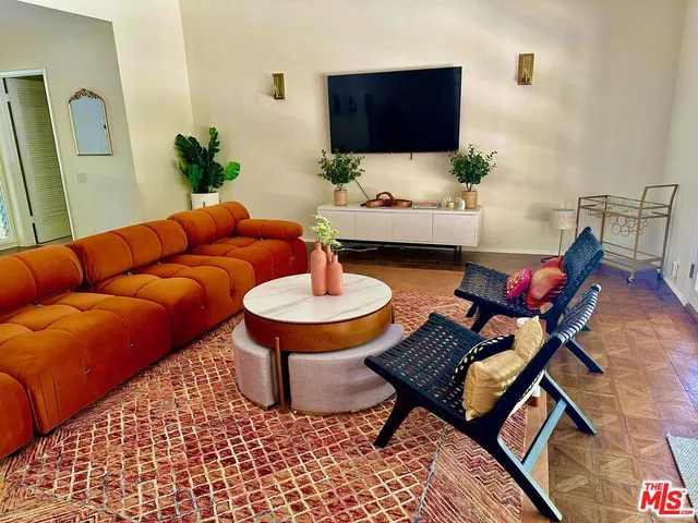 a living room with furniture and a rug