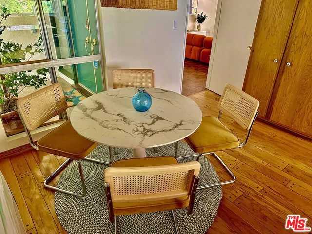 a dining room with furniture and wooden floor