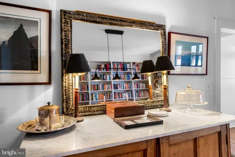 a living room with lots of books and a book shelf