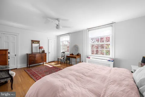 a bedroom with a bed furniture and a book shelf