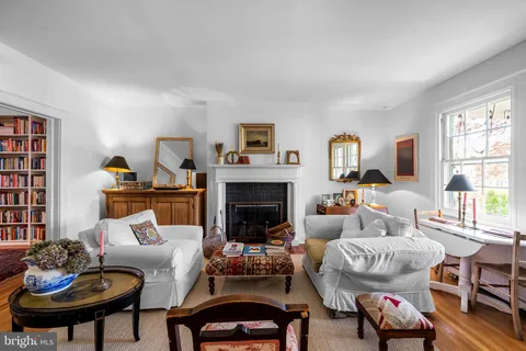 a living room with furniture fireplace and a window