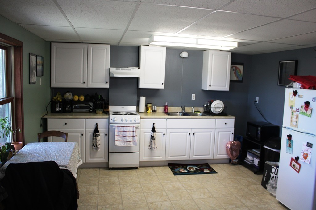 206 East Colrain Road Colrain, MA 01340 - Photo 21 of 27 a kitchen with white cabinets and appliances