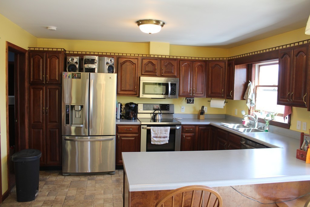 206 East Colrain Road Colrain, MA 01340 - Photo 6 of 27 a kitchen with granite countertop a refrigerator and a sink