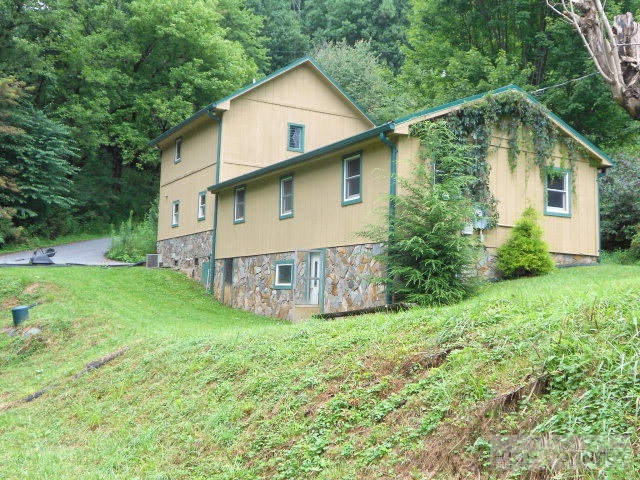 1172 Orchard Road Deep Gap, NC 28618 - Photo 1 of 14 a view of a house with backyard and garden