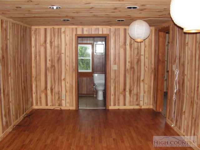 1172 Orchard Road Deep Gap, NC 28618 - Photo 3 of 14 a view of a room with wooden floor and windows