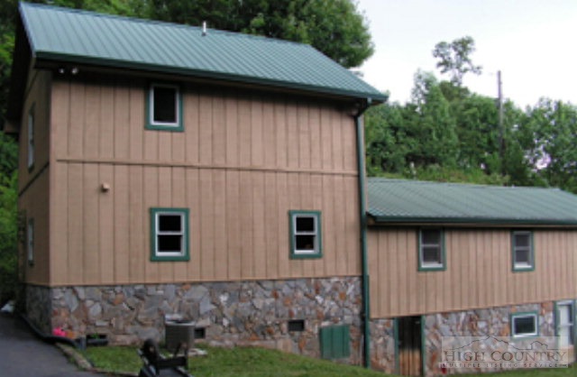 1172 Orchard Road Deep Gap, NC 28618 - Photo 8 of 14 a house with lots of trees in the background