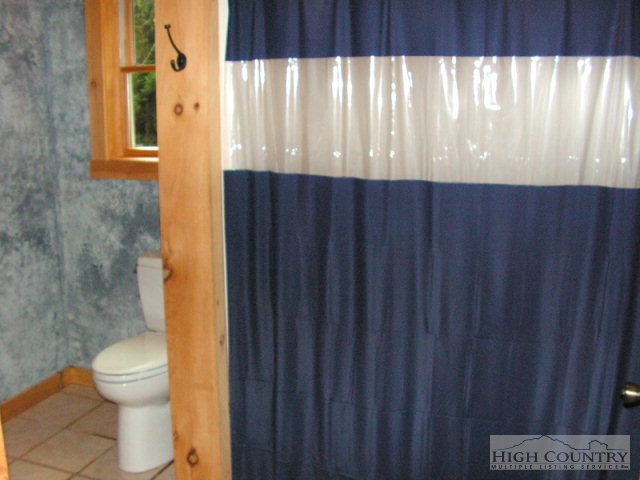 1172 Orchard Road Deep Gap, NC 28618 - Photo 10 of 14 a bathroom with a sink and a toilet