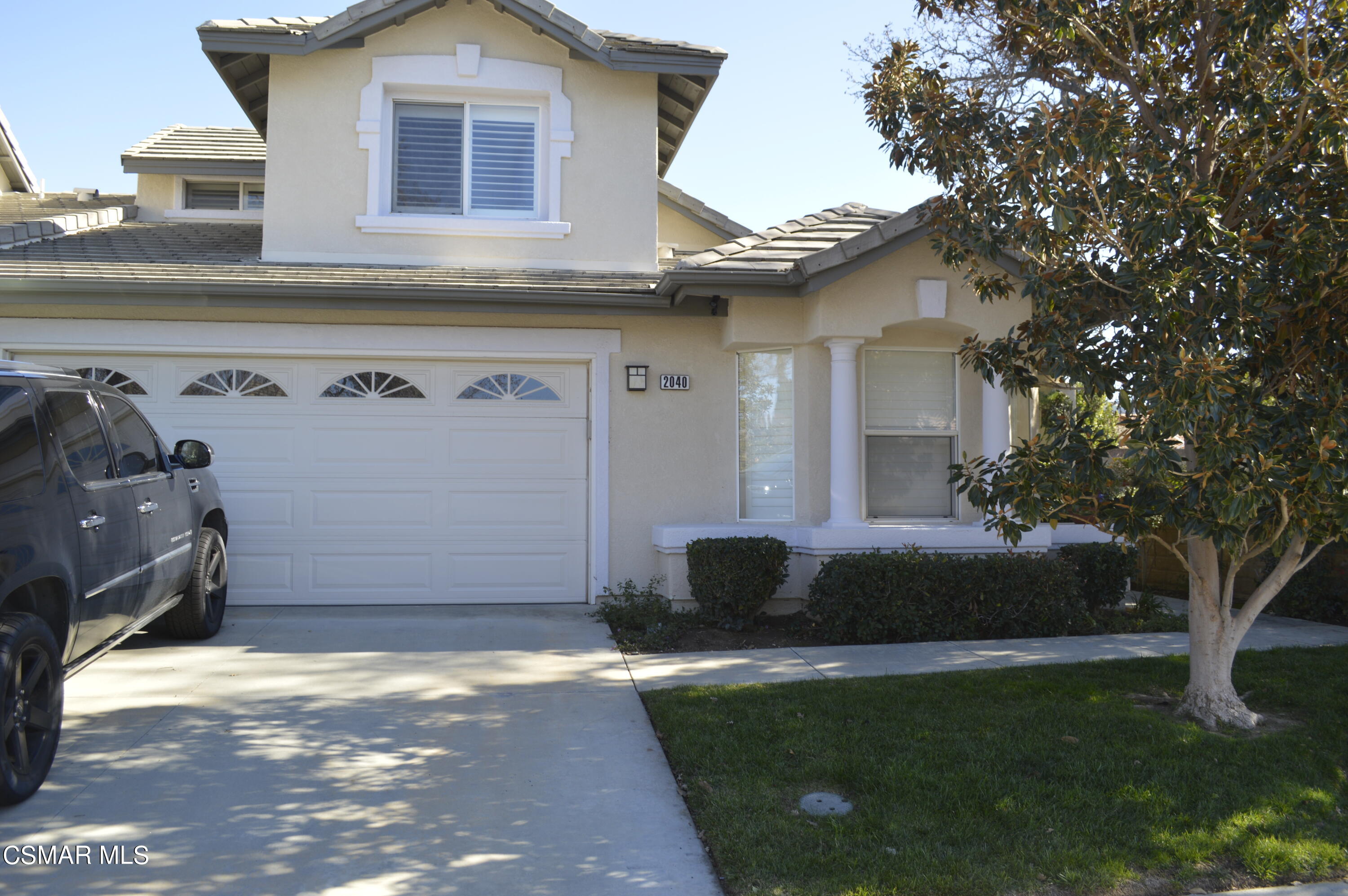 2040 Freesia Avenue Simi Valley, CA 93063 - Photo 1 of 23 a front view of a house with garden