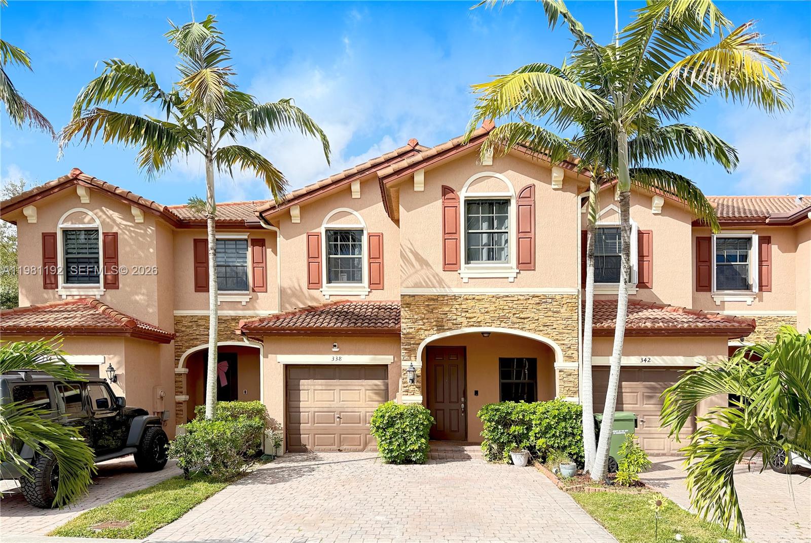 338 Northeast 37th Avenue Homestead, FL 33033 - Photo 1 of 19 a view of a white house with a small yard and potted plants