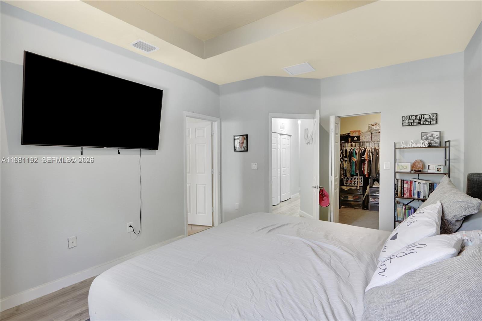 338 Northeast 37th Avenue Homestead, FL 33033 - Photo 12 of 19 a bedroom with a bed and a flat screen tv