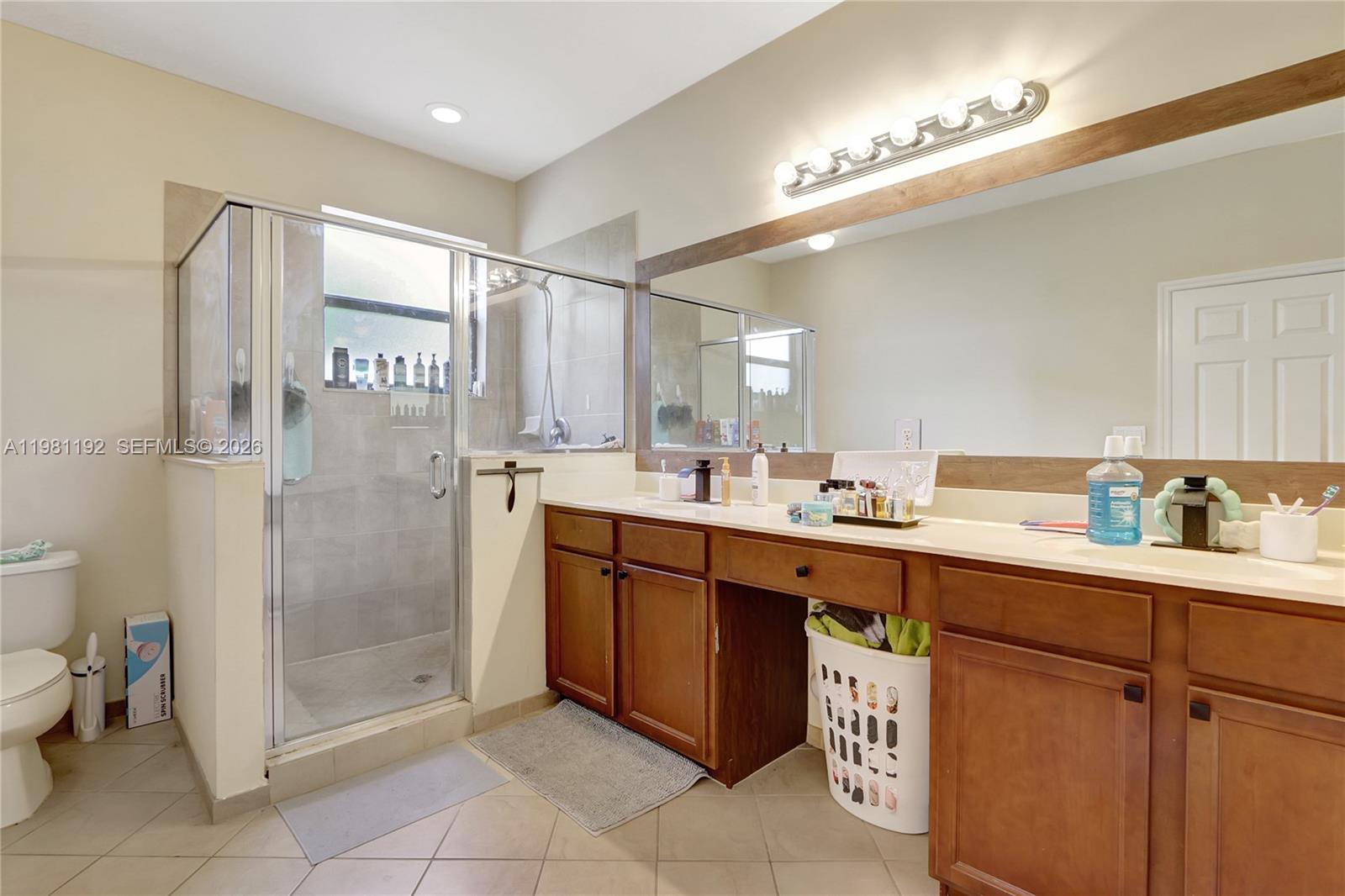338 Northeast 37th Avenue Homestead, FL 33033 - Photo 13 of 19 a spacious bathroom with a shower sink and mirror