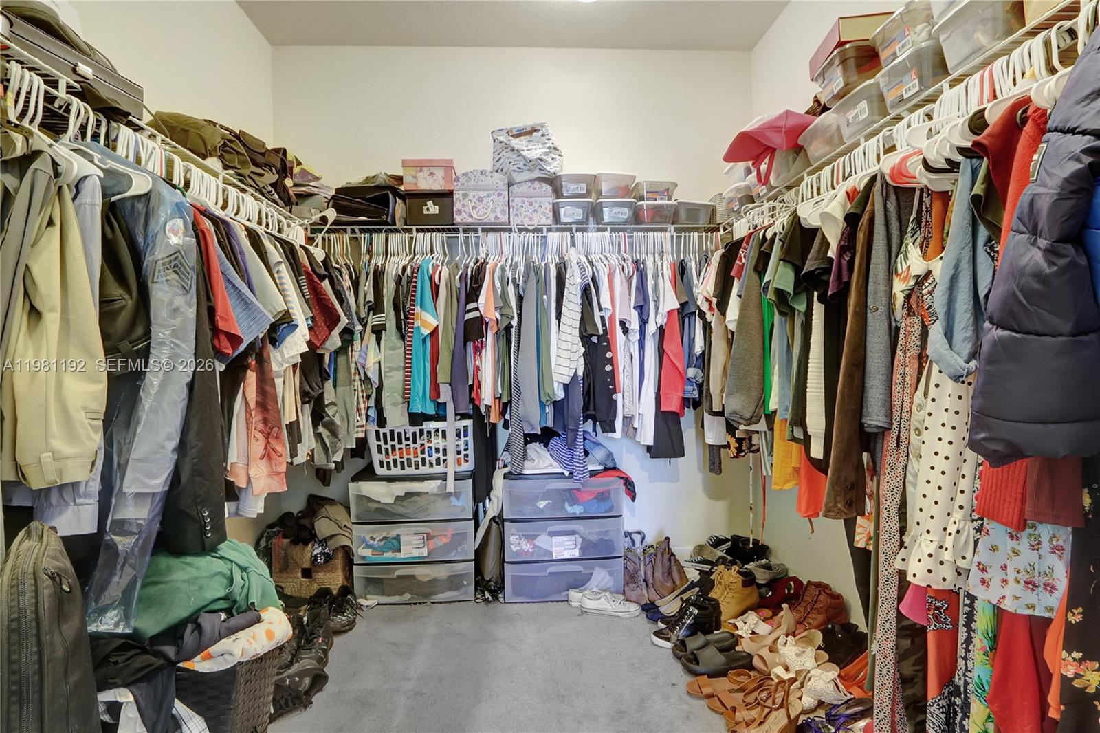 338 Northeast 37th Avenue Homestead, FL 33033 - Photo 14 of 19 a view of walk in closet with clothes