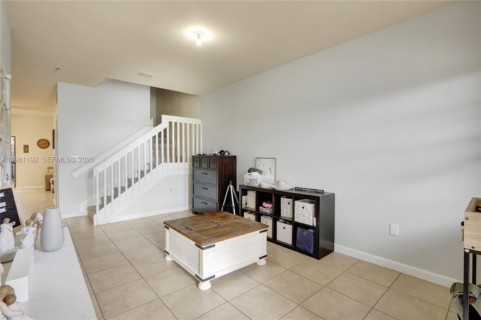 338 Northeast 37th Avenue Homestead, FL 33033 - Photo 2 of 19 a living room with stairs and a furniture