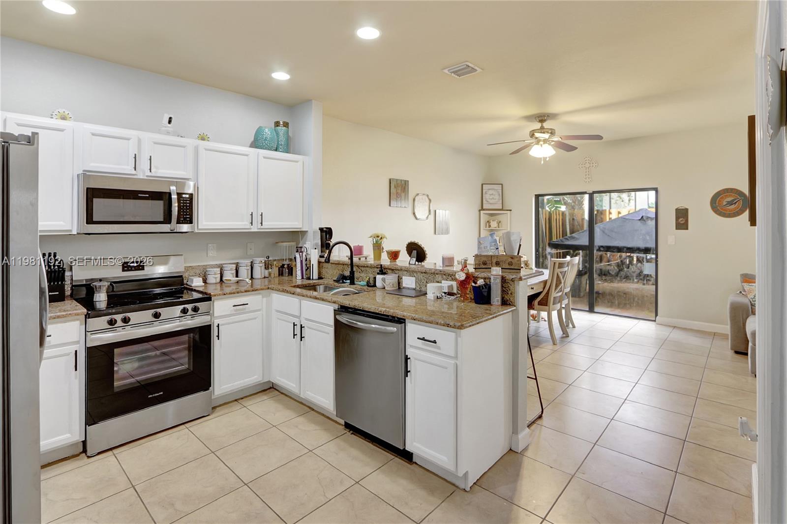 338 Northeast 37th Avenue Homestead, FL 33033 - Photo 4 of 19 a kitchen with cabinets and chairs