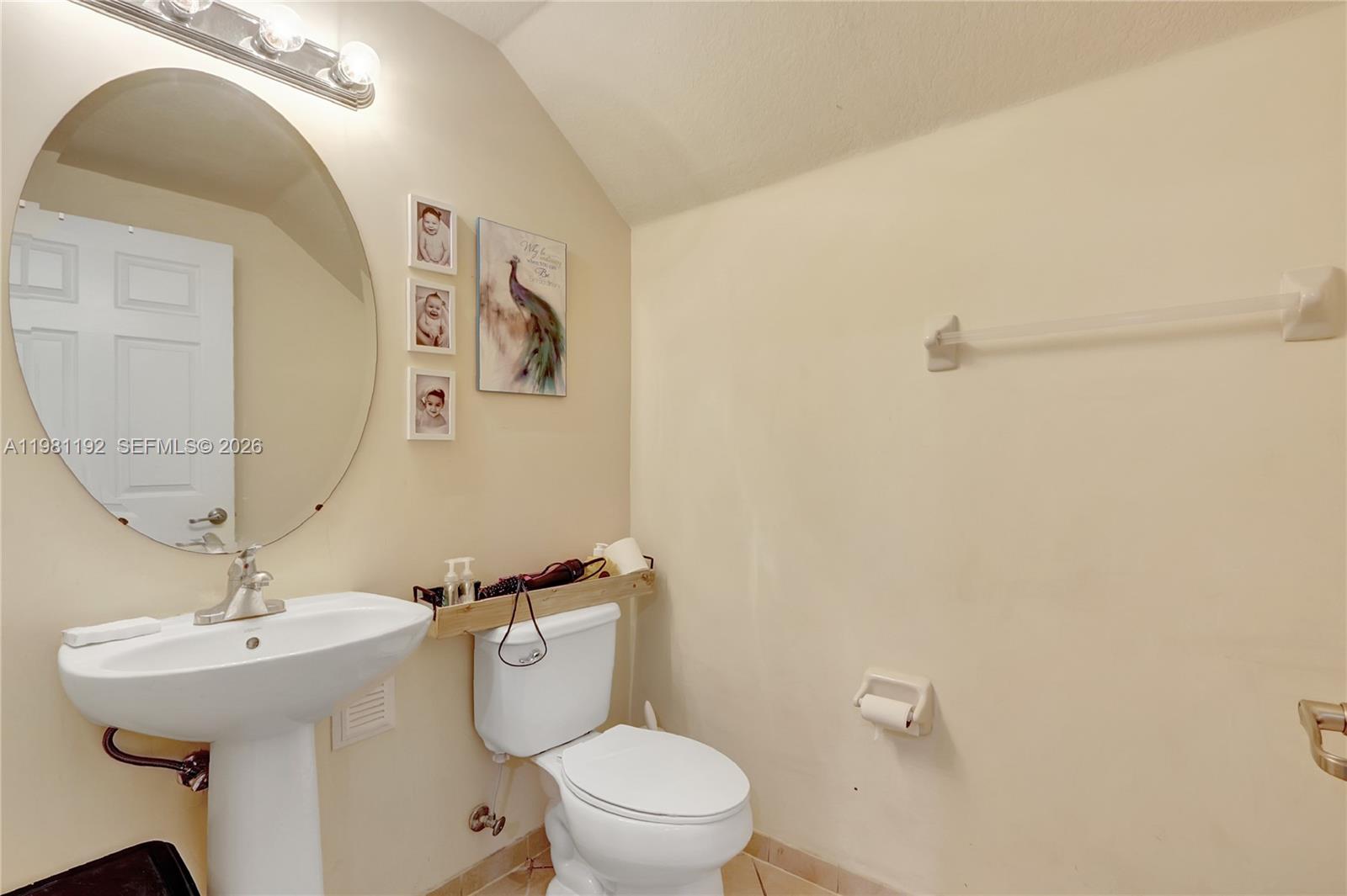 338 Northeast 37th Avenue Homestead, FL 33033 - Photo 8 of 19 a bathroom with a toilet sink and mirror
