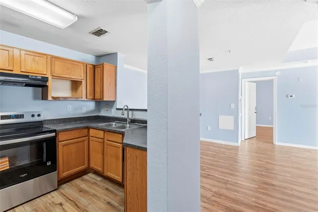 a kitchen with stainless steel appliances granite countertop a stove and a sink
