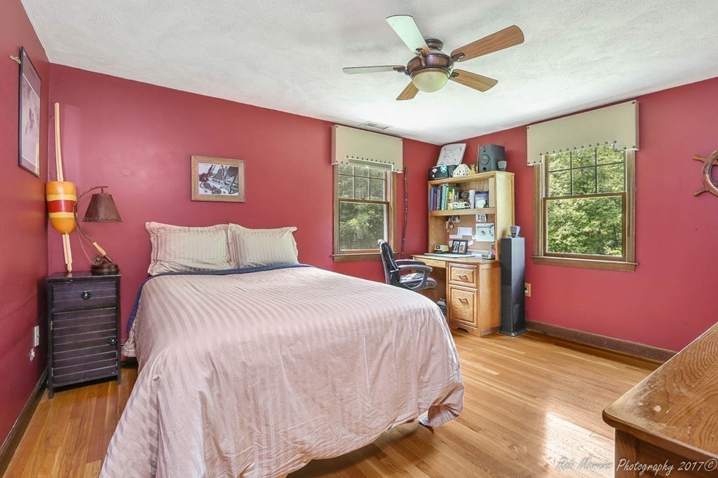 19 Bare Hill Road Boxford, MA 01921 - Photo 18 of 30 a bedroom with a bed and a bookshelf with wooden floor