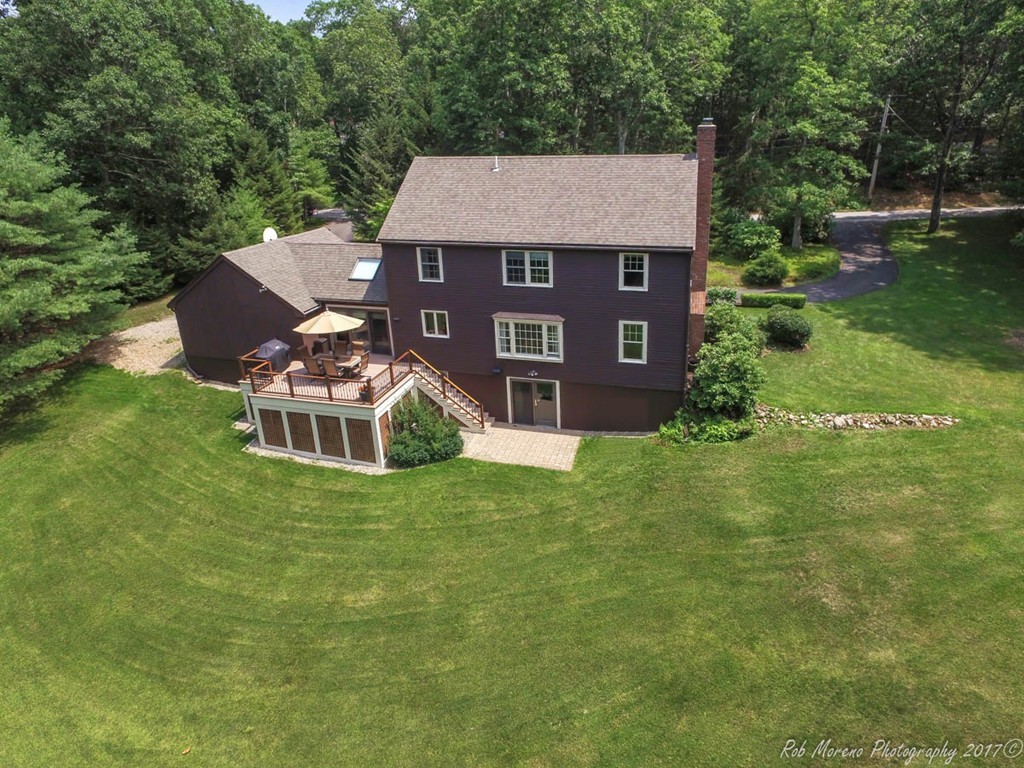 19 Bare Hill Road Boxford, MA 01921 - Photo 2 of 30 a front view of a house with a yard garage and outdoor seating