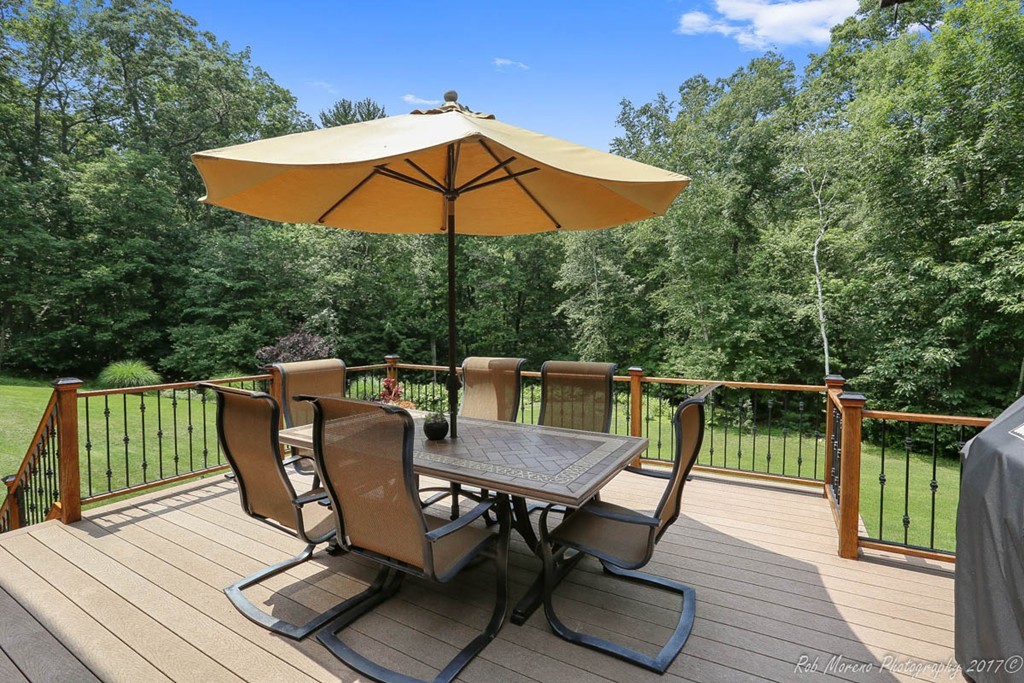 19 Bare Hill Road Boxford, MA 01921 - Photo 3 of 30 an outdoor sitting area with furniture and umbrella