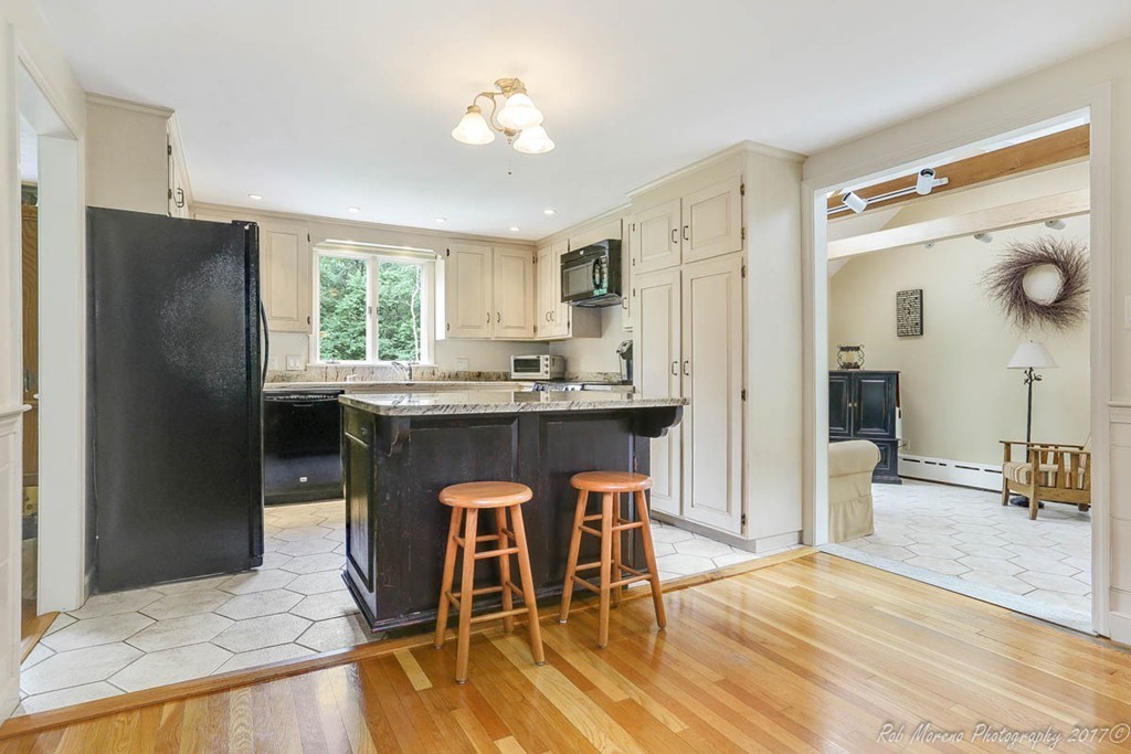19 Bare Hill Road Boxford, MA 01921 - Photo 5 of 30 a kitchen with stainless steel appliances granite countertop a dining table chairs refrigerator and sink