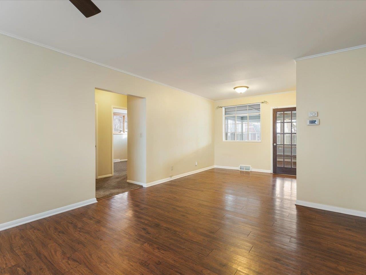 4701 Highcrest Road Rockford, IL 61107 - Photo 5 of 23 an empty room with wooden floor and windows