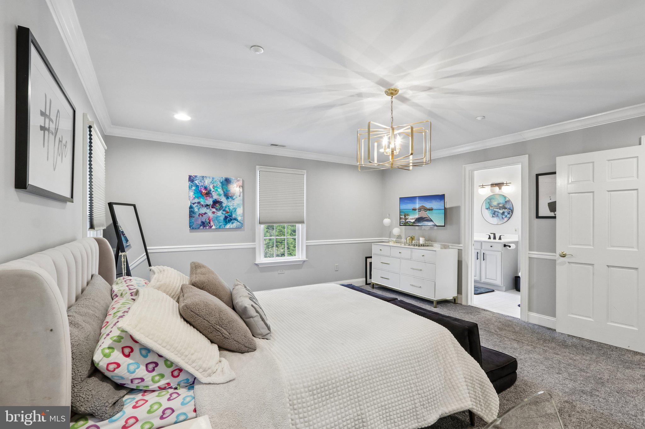 209 Welsh Road Ambler, PA 19002 - Photo 45 of 80 a bedroom with a bed and a chandelier