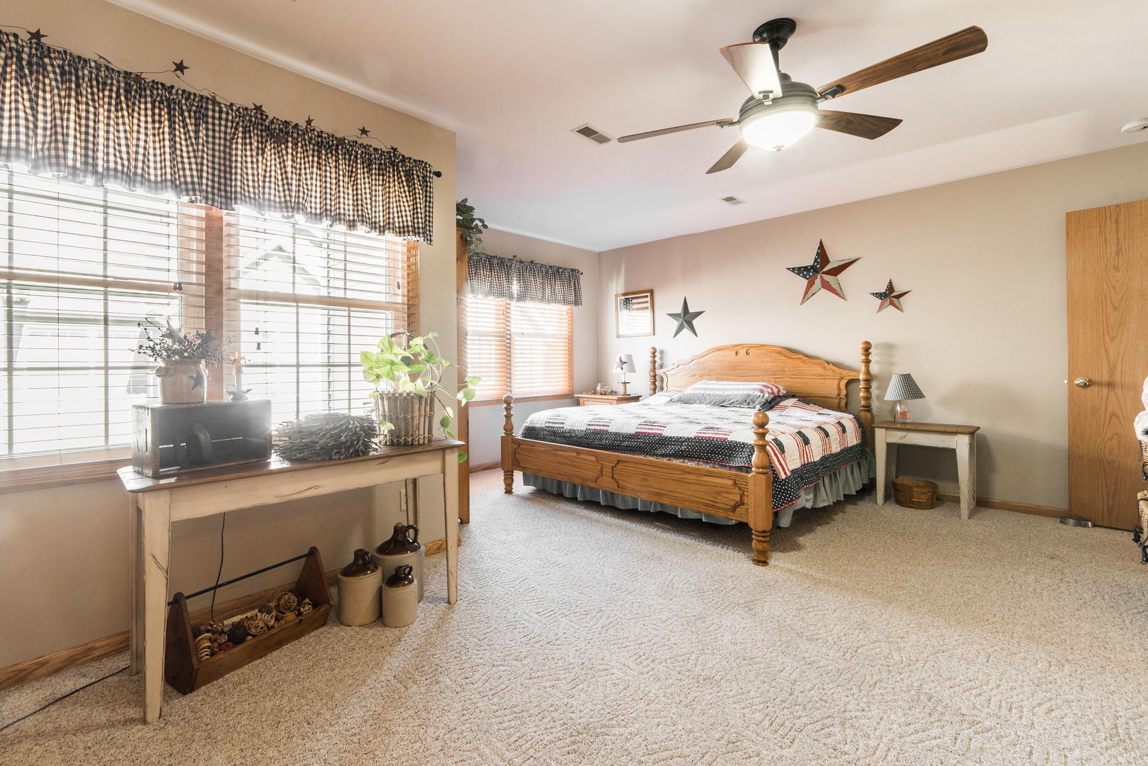 508 South Peace Road, Unit 508 Sycamore, IL 60178 - Photo 14 of 29 a bedroom with a bed a chandelier and a dresser