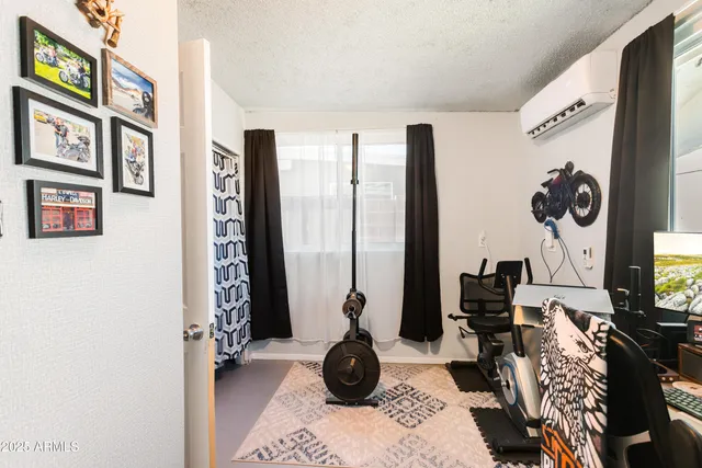 a bedroom with a bed and a ceiling fan