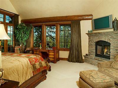 2509 Daybreak Ridge Road Avon, CO 81620 - Photo 5 of 19 a bedroom with a bed and a fireplace