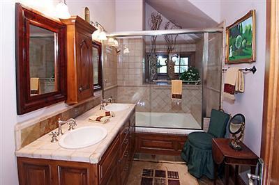 2509 Daybreak Ridge Road Avon, CO 81620 - Photo 7 of 19 a bathroom with a granite countertop sink a mirror and shower