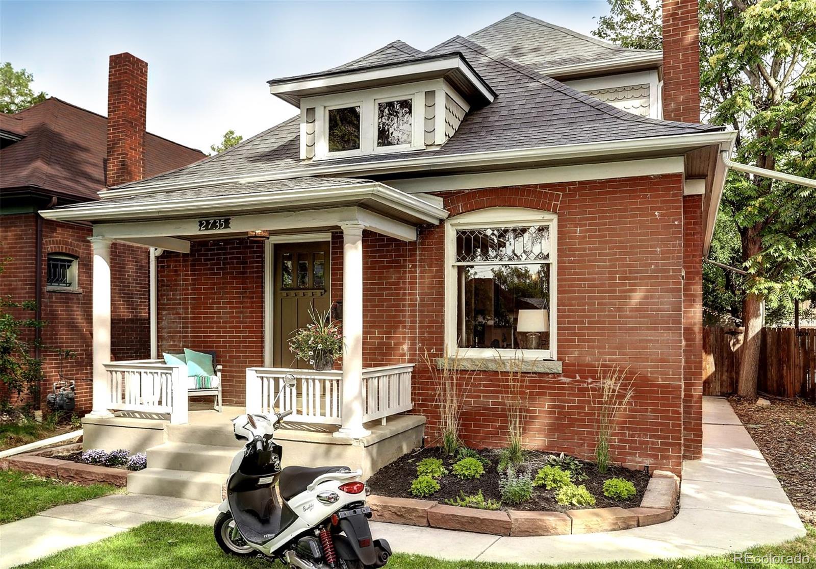 a front view of a house with outdoor seating