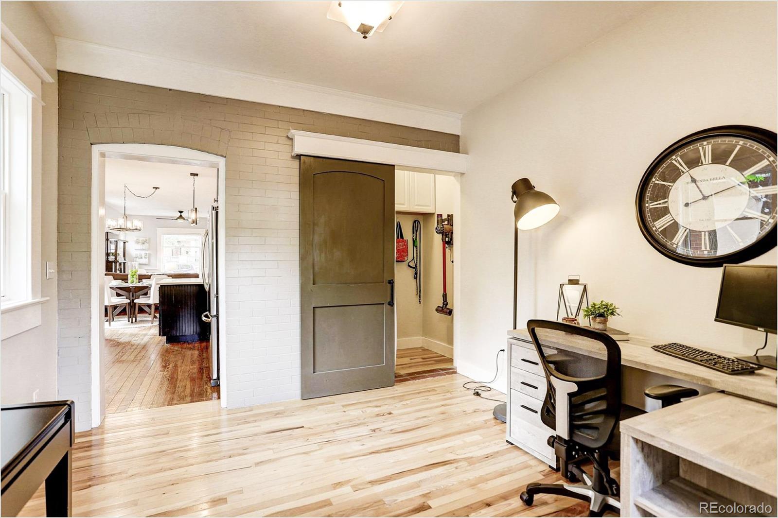 2735 West 35th Avenue Denver, CO 80211 - Photo 16 of 33 a view of a hallway with wooden floor and furniture