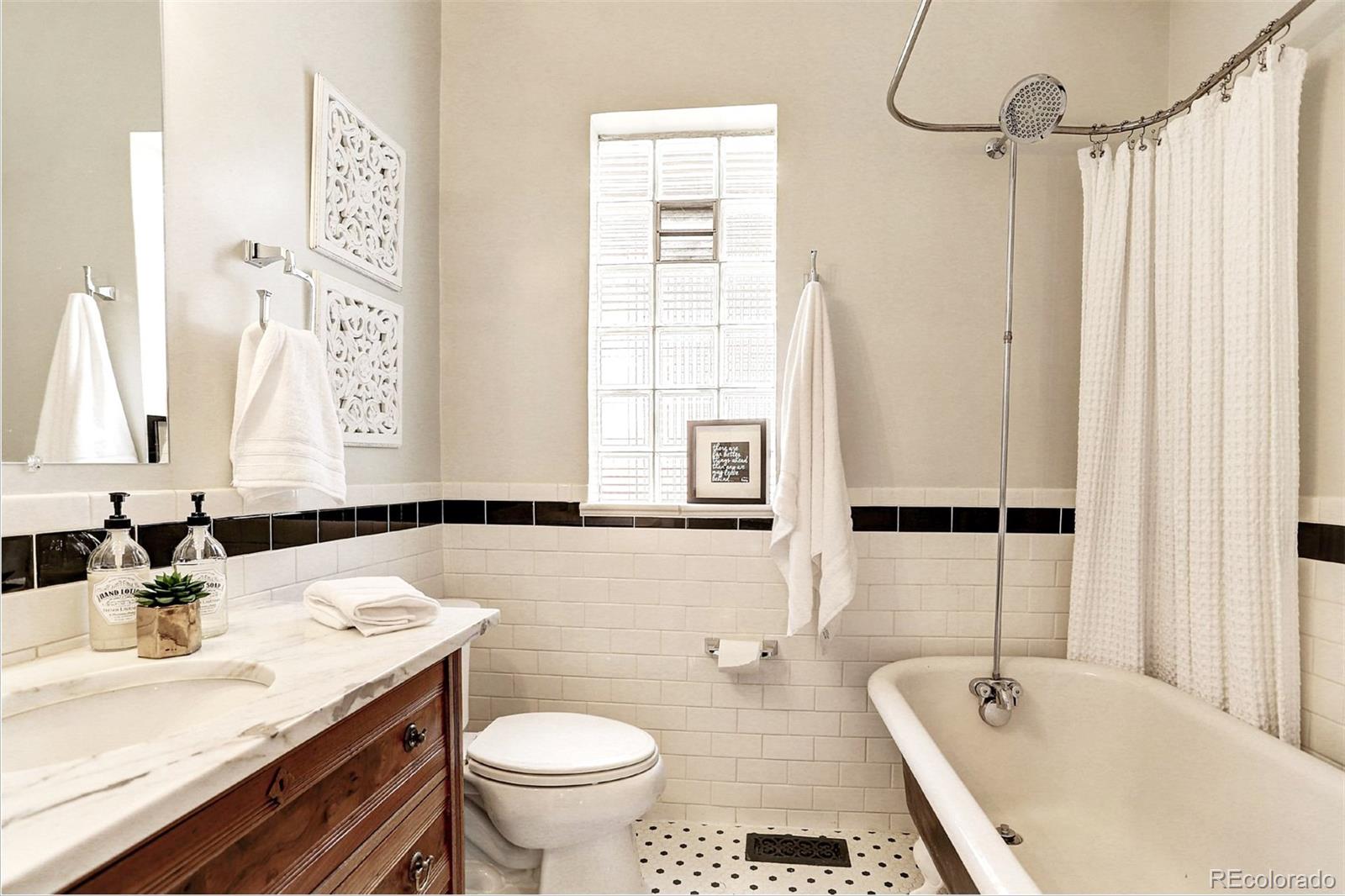 2735 West 35th Avenue Denver, CO 80211 - Photo 10 of 33 a bathroom with a granite countertop sink and a mirror