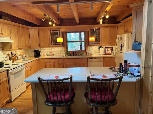 a kitchen with cabinets a refrigerator and a sink