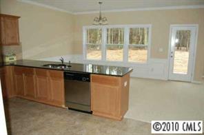 274 Ranlo Avenue Gastonia, NC 28054 - Photo 2 of 8 a kitchen with granite countertop a sink and a stove