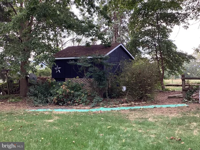 a brick house with a tree in front of it