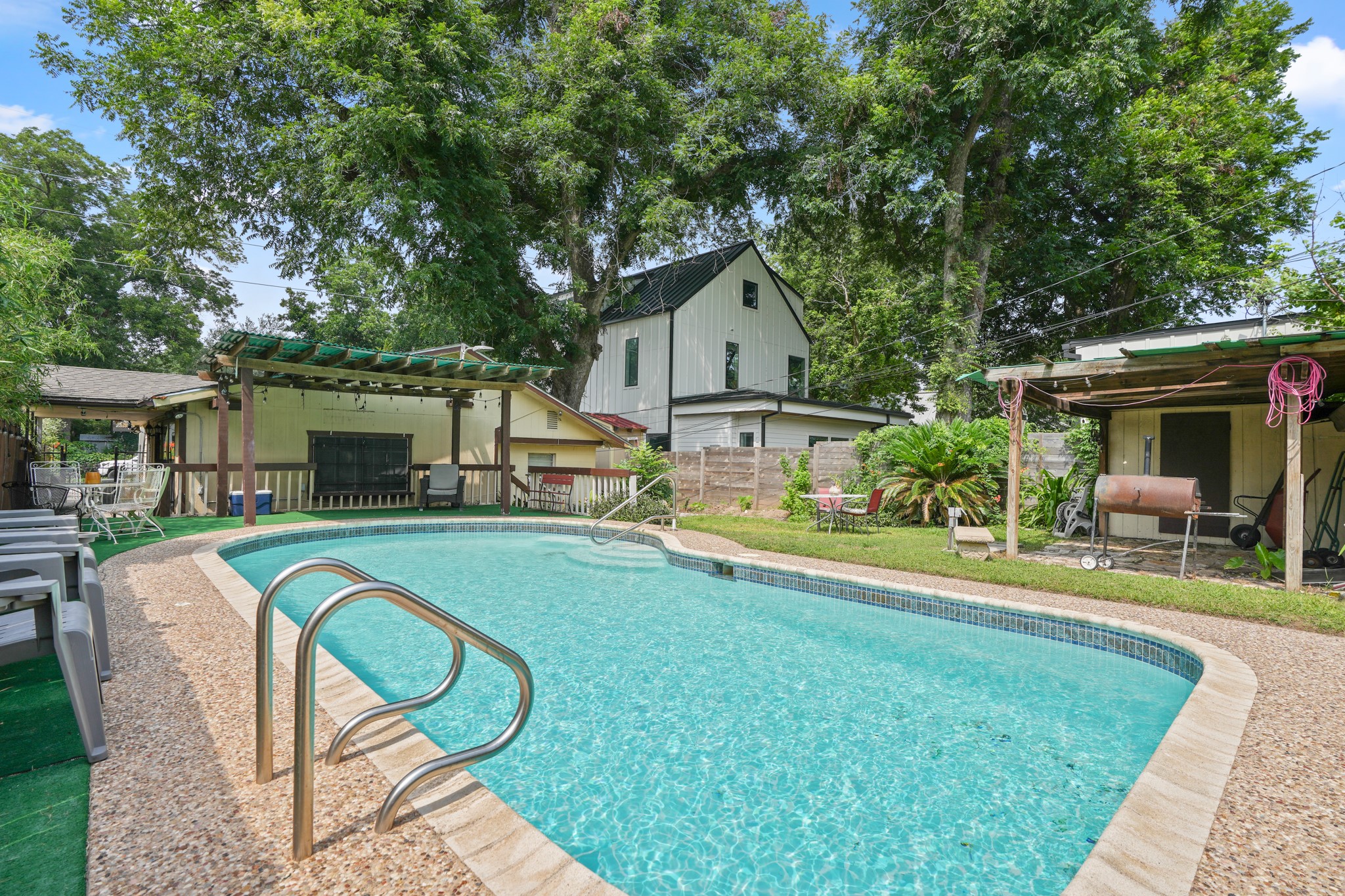1908 Holly Street Austin, TX 78702 - Photo 22 of 22 An inviting in-ground pool offers refreshing relief, surrounded by established trees and a privacy fence.